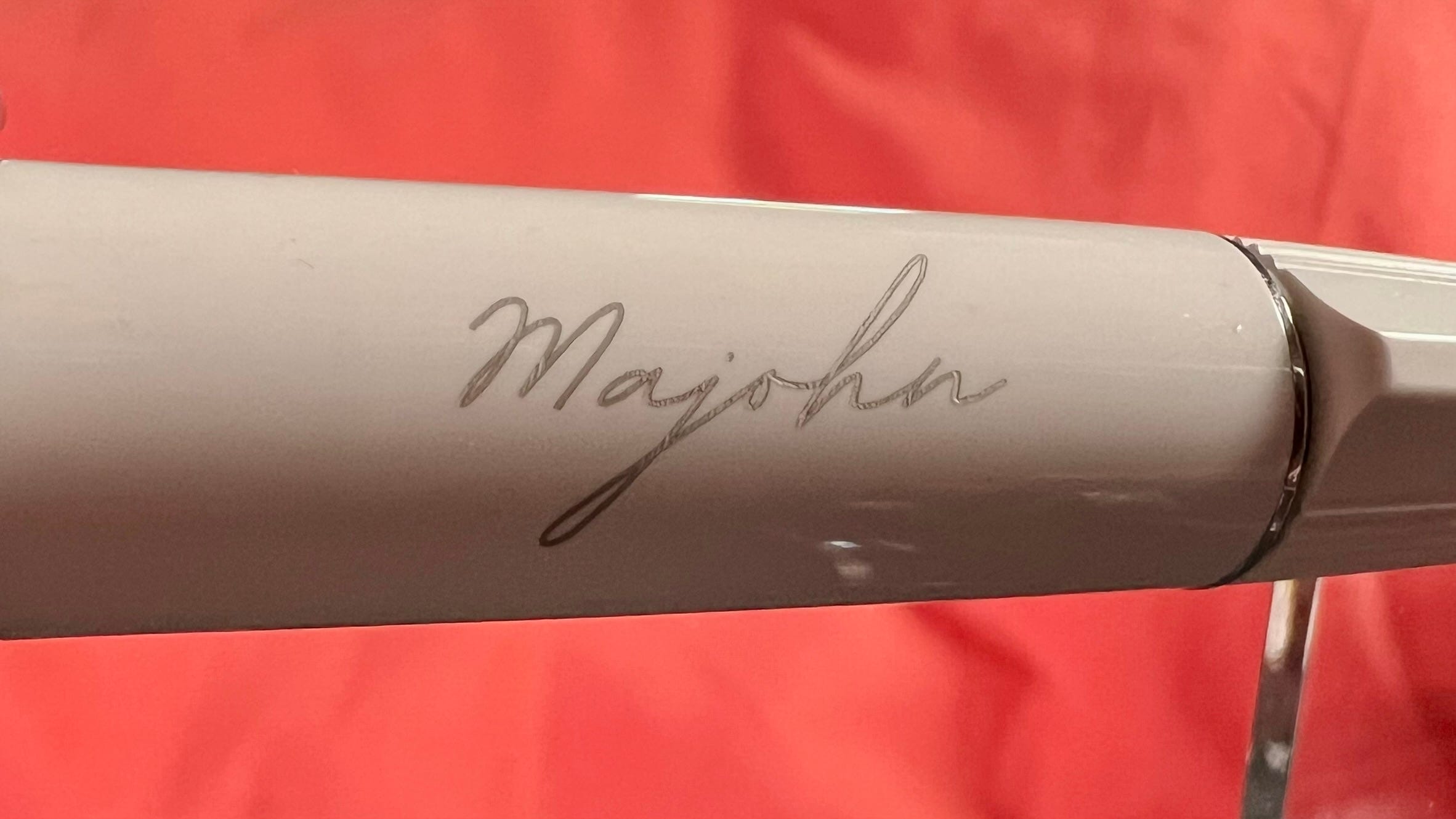 A closeup of the A3 showing the silver hand-written styled "Majohn" branding on the white body. 