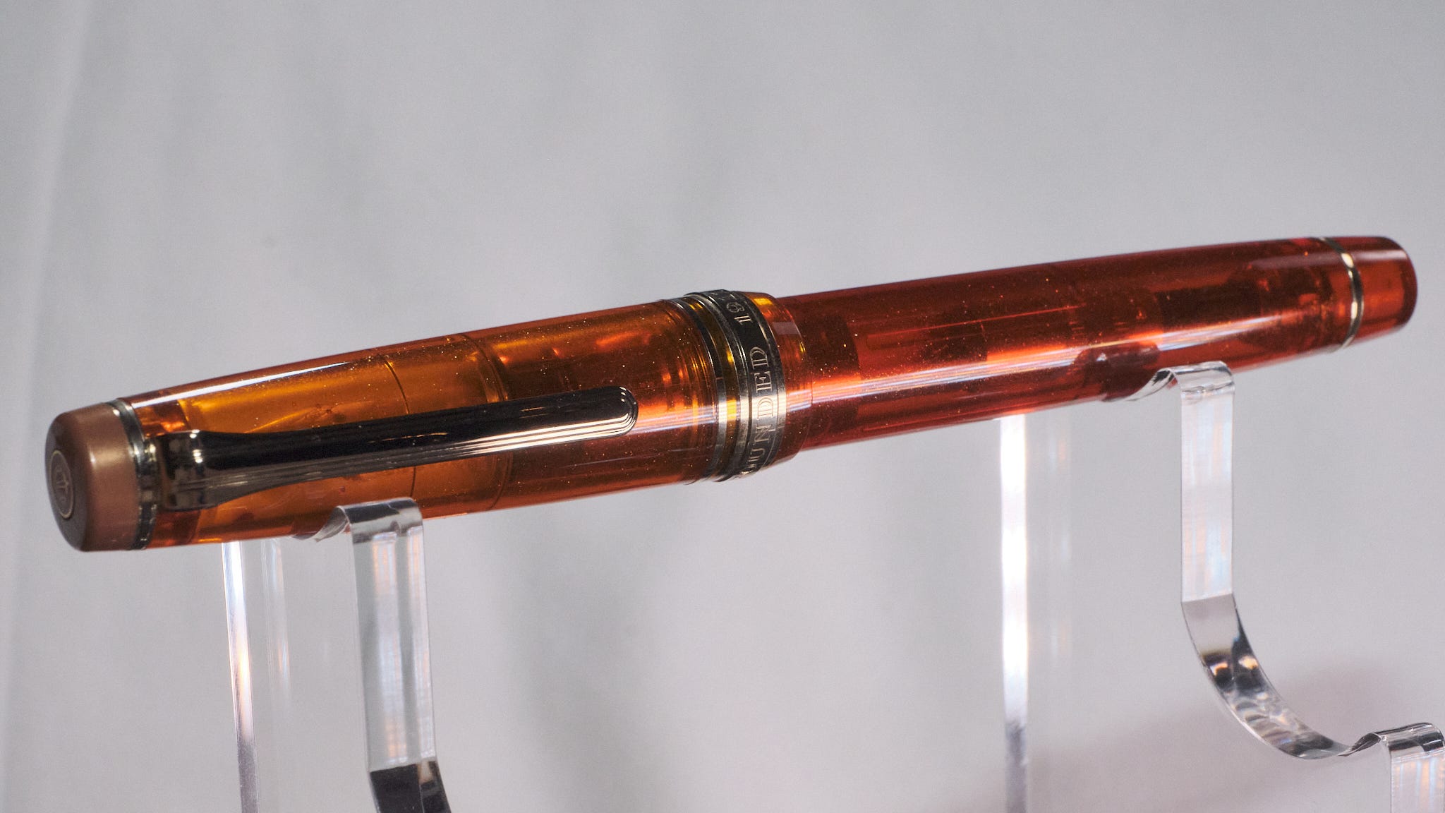 Photo of a sparkly transparent orange capped fountain pen