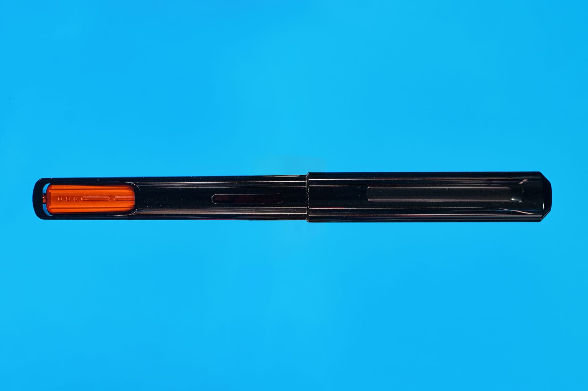 Photo of the black & orange Endless Captiva fountain pen on a blue background