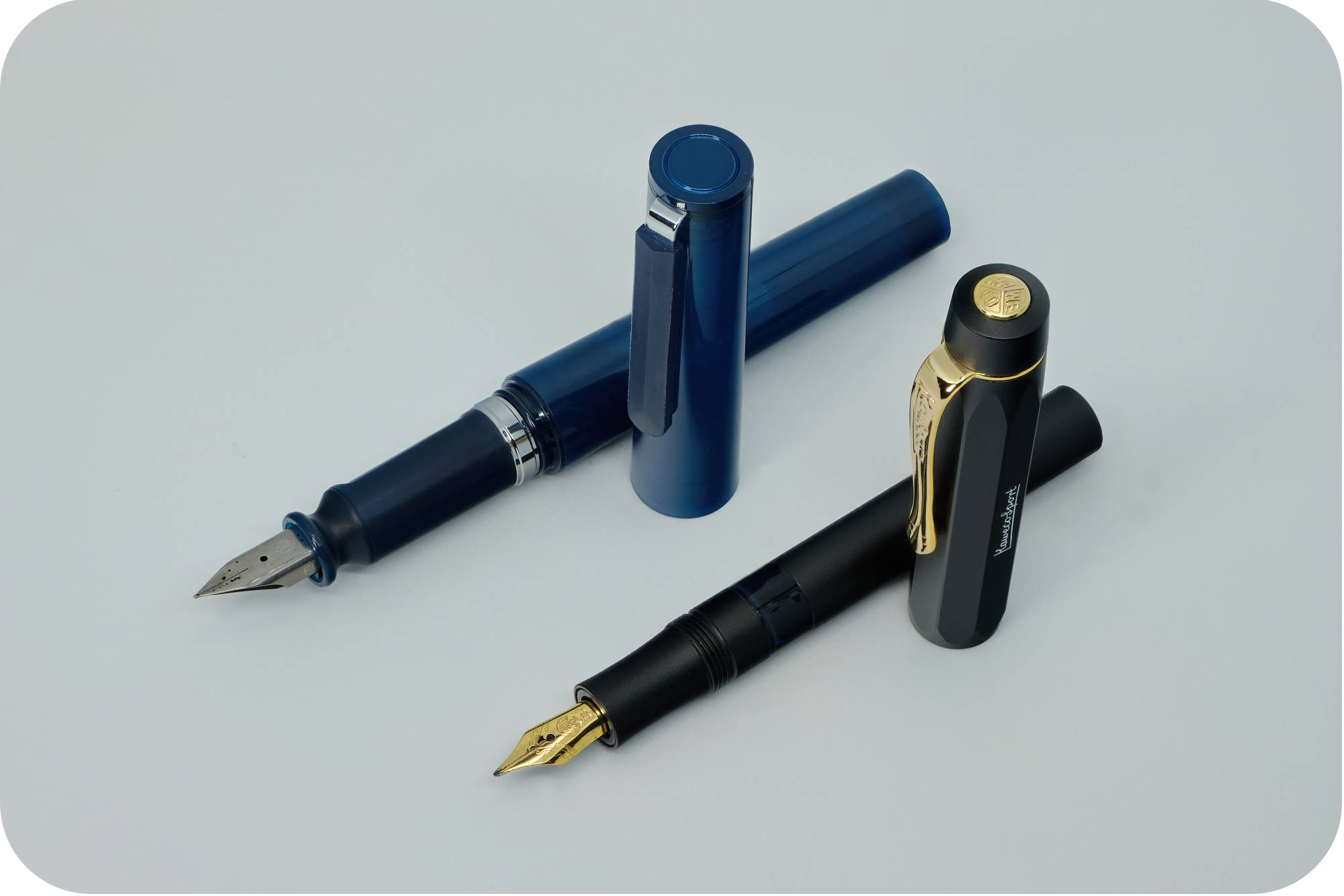 Photo of a Sailor Tuzu & Kaweco Sport Piston with their caps off on a white background