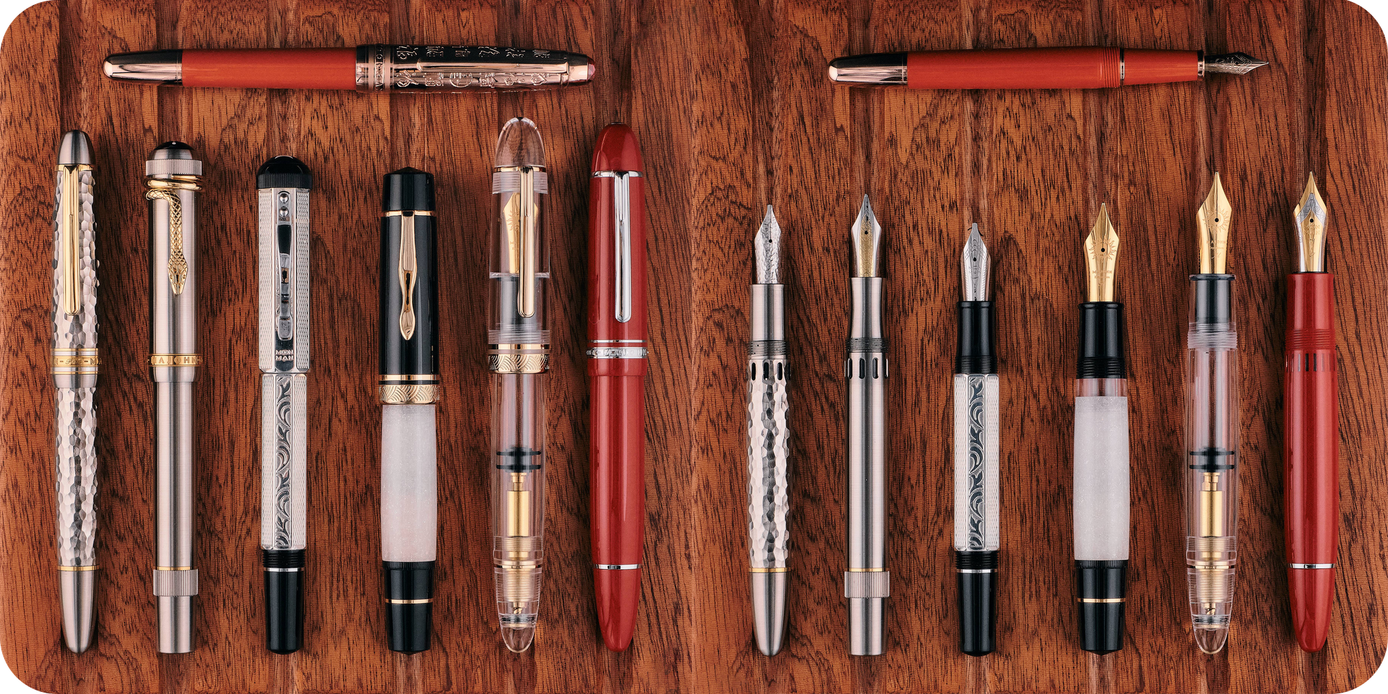 Overhead photo of the P135, P136, P137, P138, P139, P140, & P141 with their caps on & off on a wooden board