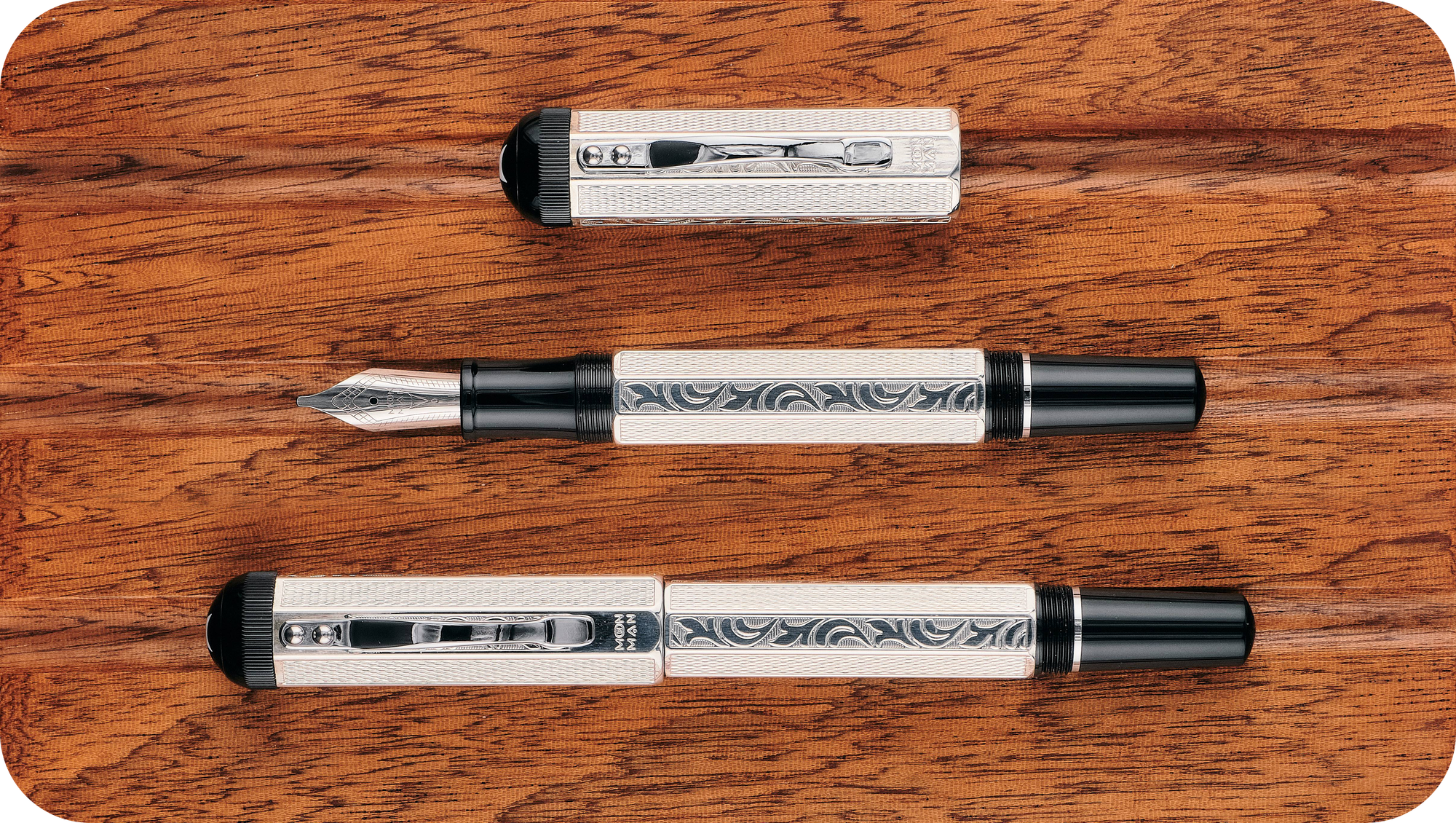 Overhead photo of the silver P138 with its cap on & off on a wooden board