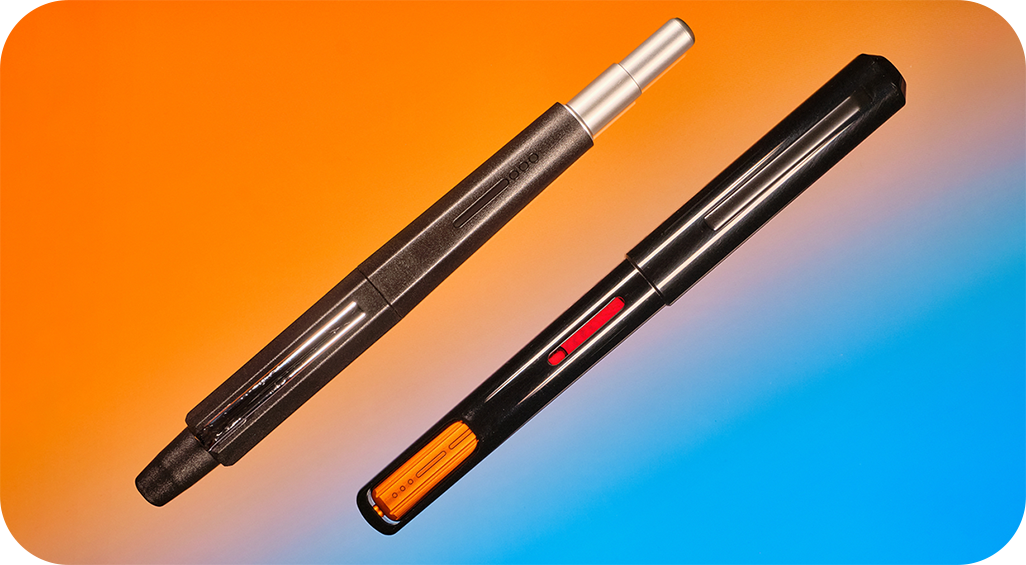 Photo of a retractable fountain pen & a captive converter fountain pen on an orange & blue background