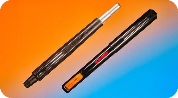 Photo of a retractable fountain pen & a captive converter fountain pen on an orange & blue backgroun