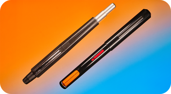 Photo of a retractable fountain pen & a captive converter fountain pen on an orange & blue background